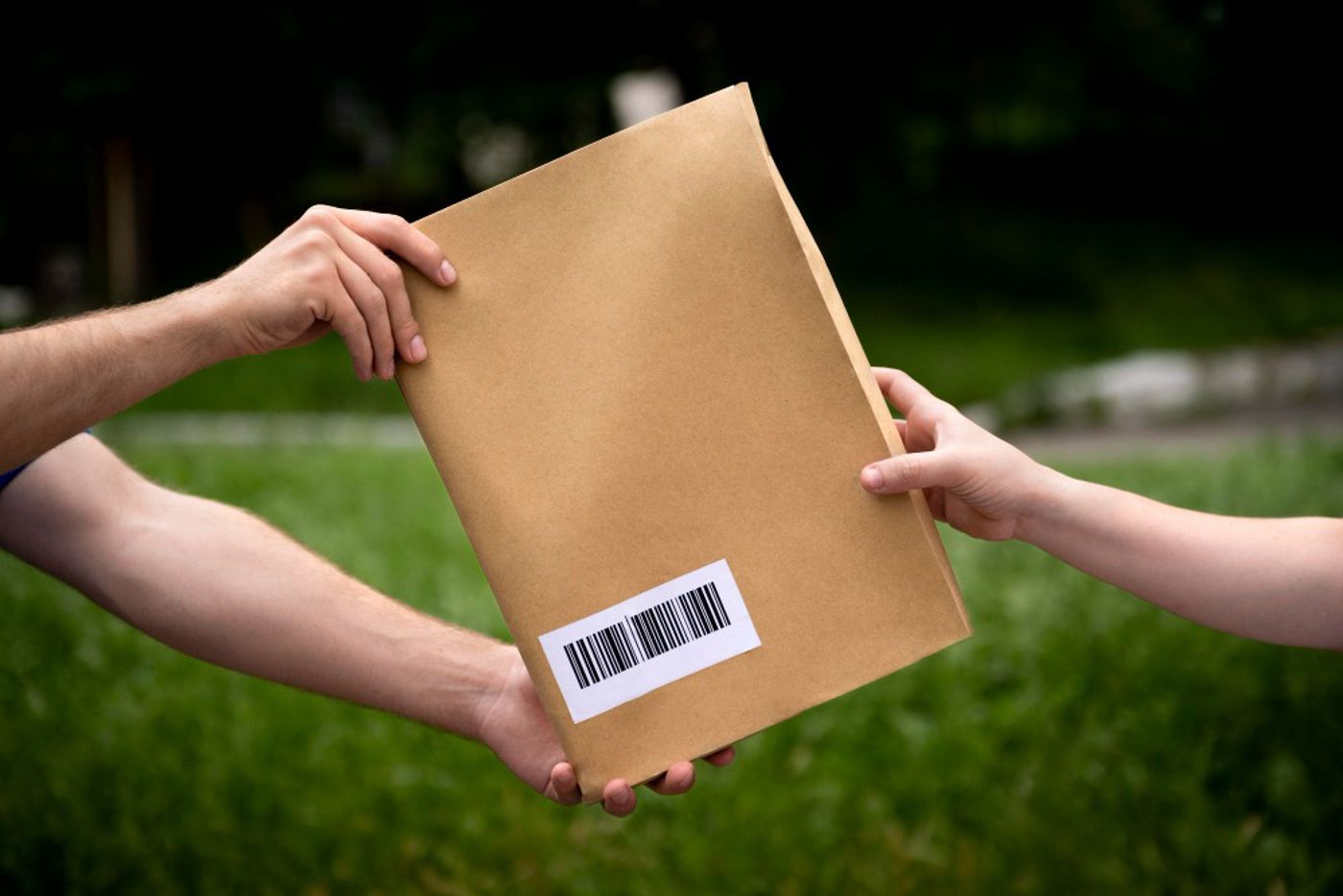 Handen die pakket overgeven aan andere handen Handen die pakket overgeven aan andere handen